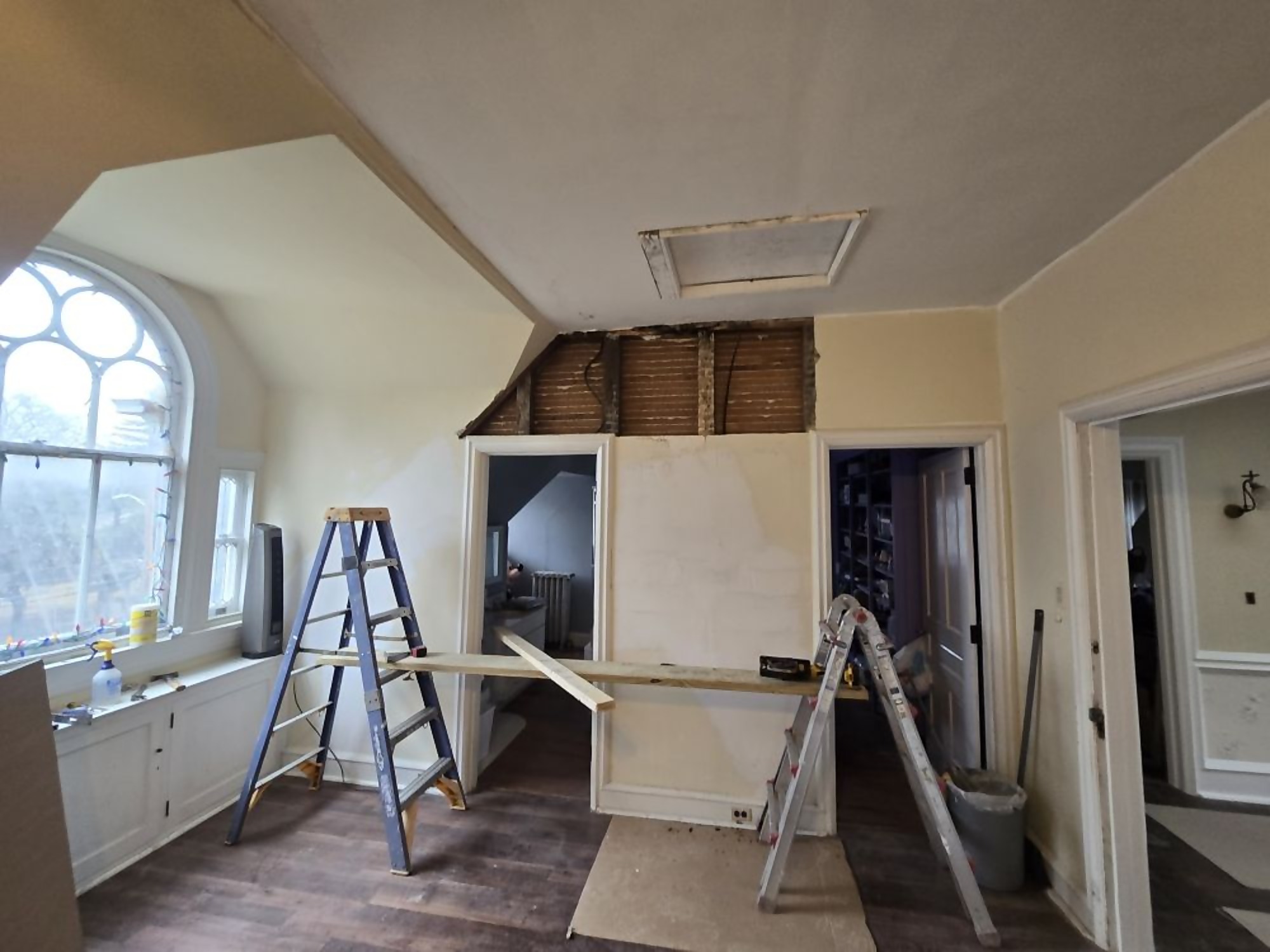 Room with drywall repair and prep work underway before finishing