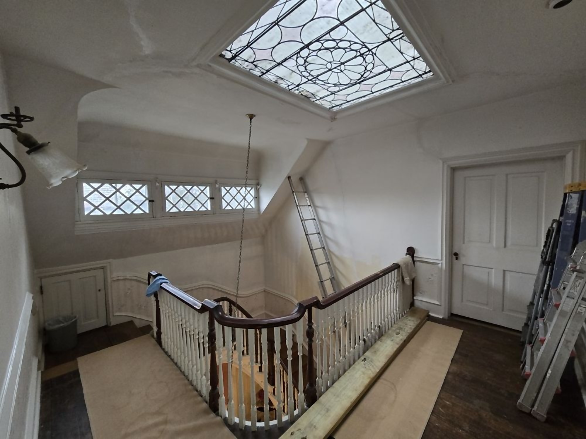 Stair hall with railings and walls prepped before Pro One repainting