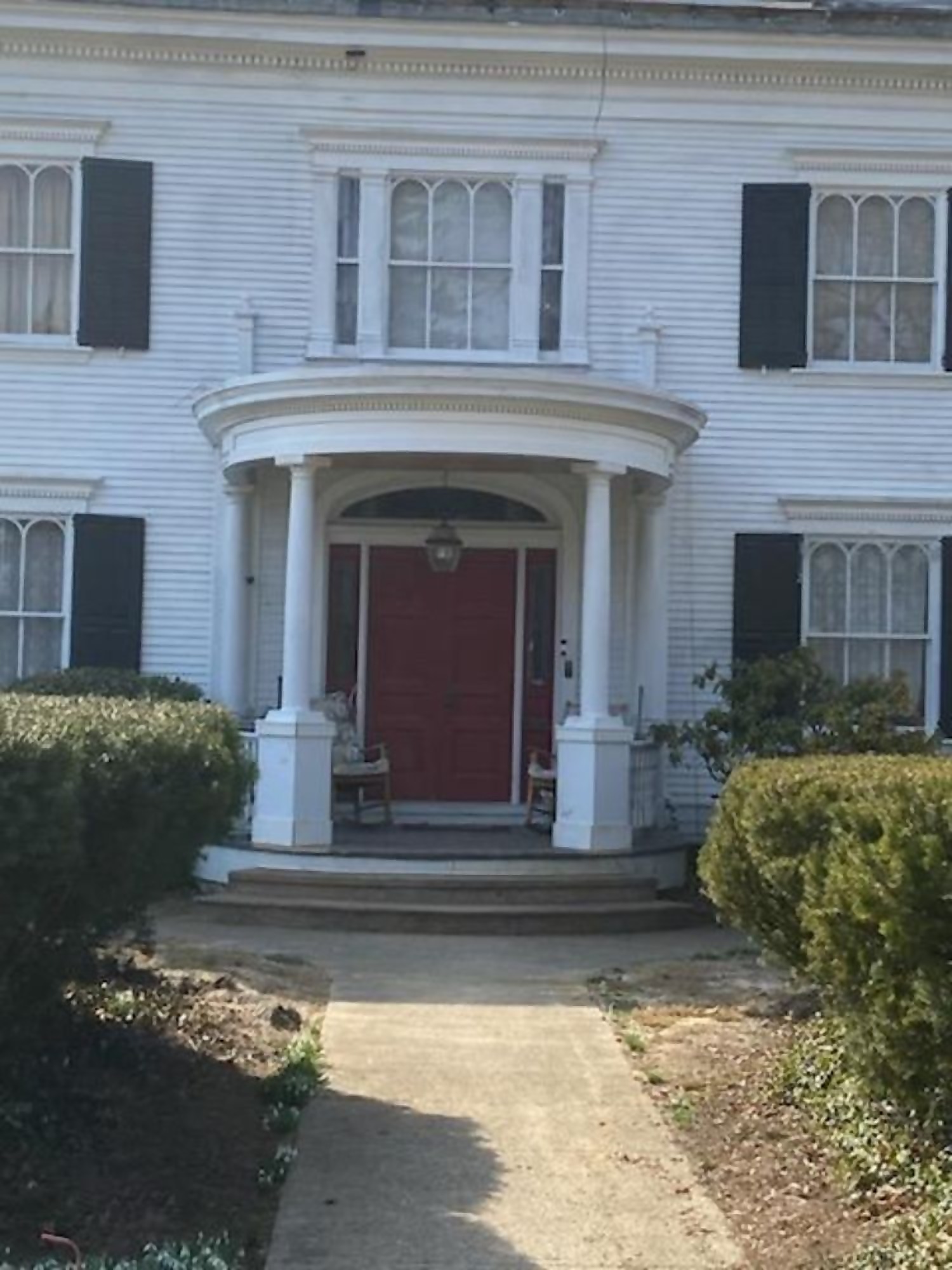 Historic white colonial home exterior restored and repainted by Pro One