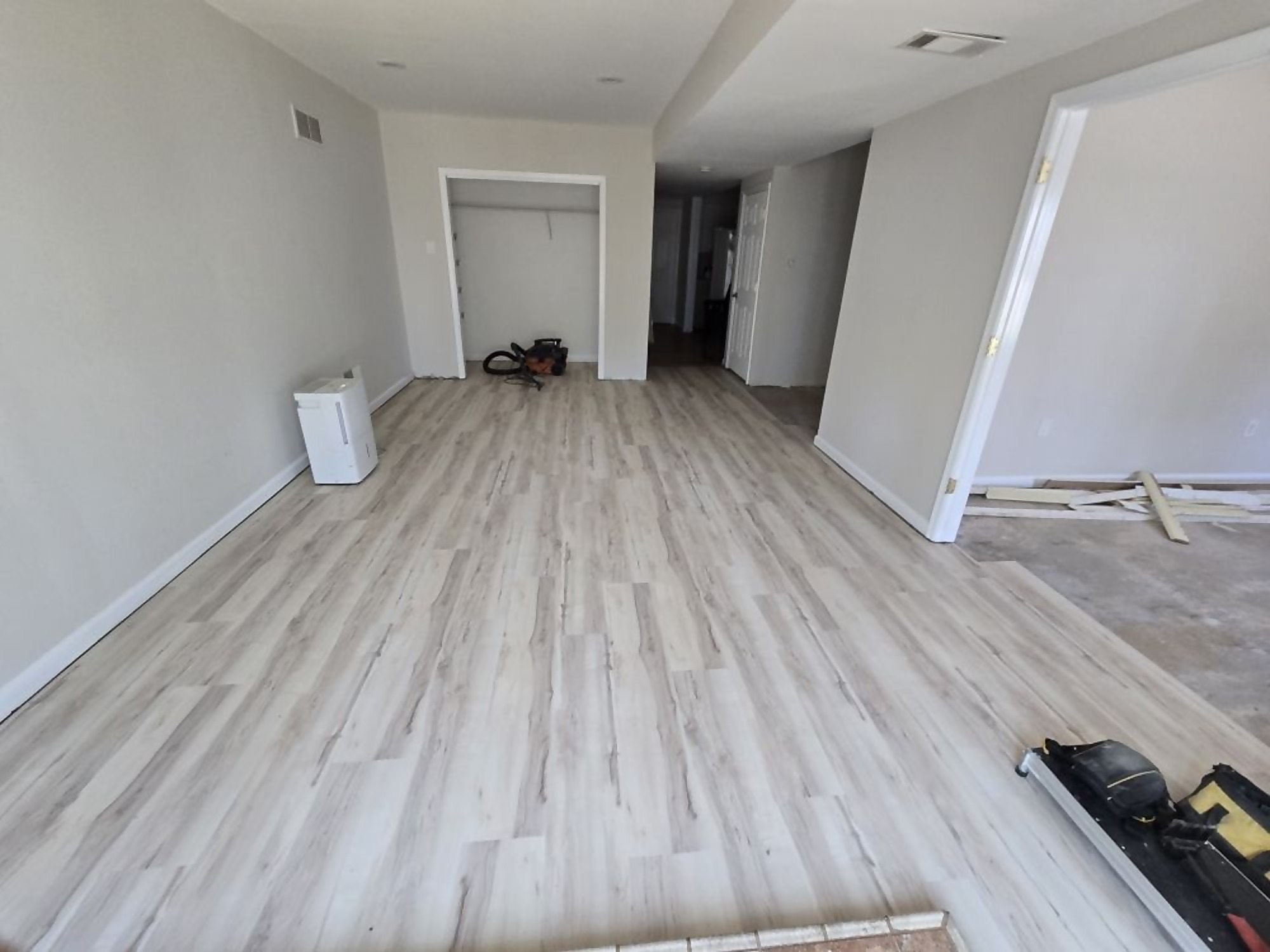 New luxury vinyl plank flooring installed across an open living space