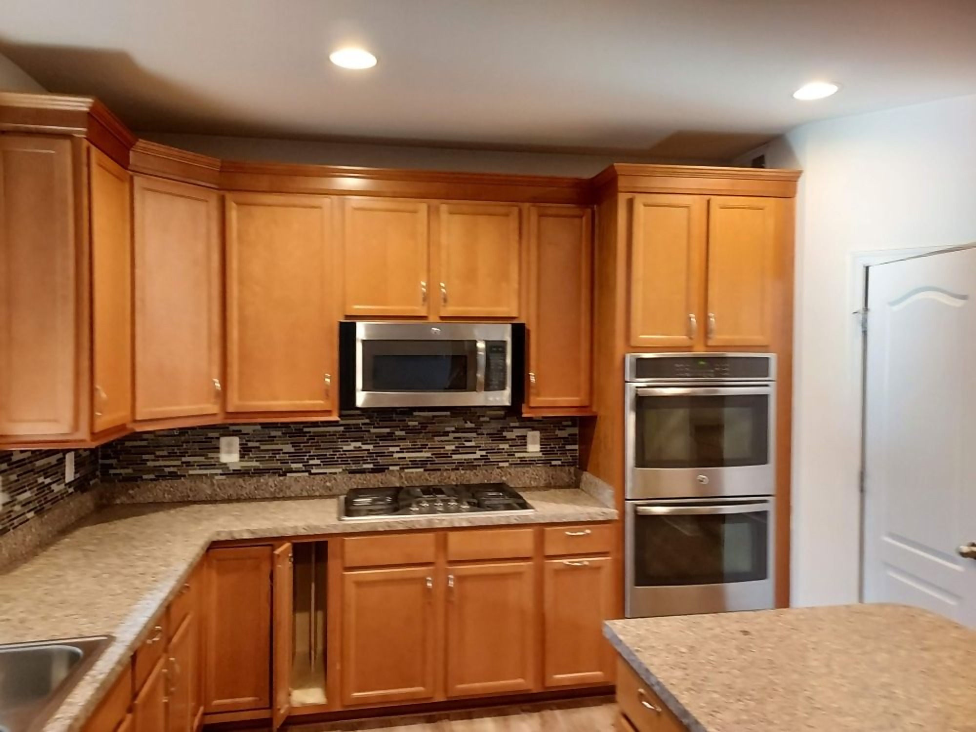 Kitchen with wood cabinets, granite counters and stainless appliances