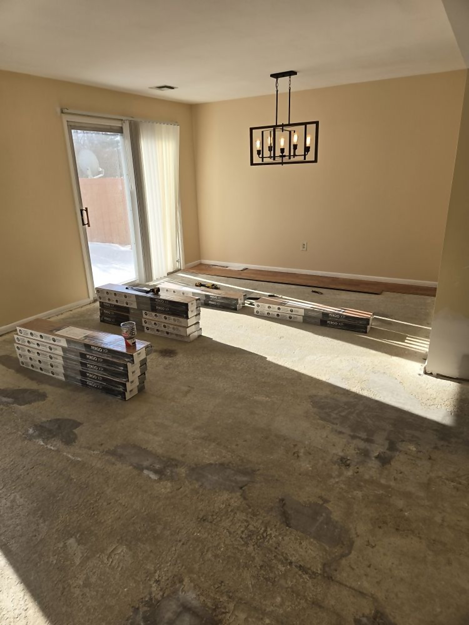 Dining room floor prepped with tile pallets staged for installation